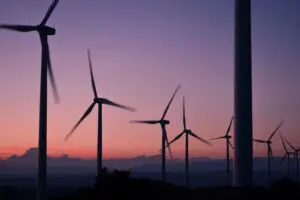 Wind turbines generating renewable energy against a clear sky, symbolising sustainability.